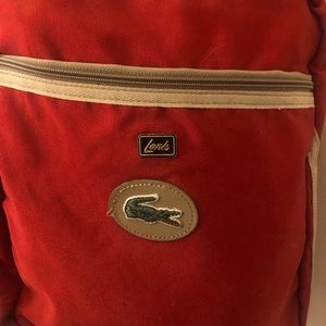 Vintage red Lark Izod Lacoste book bag with shoulder strap.